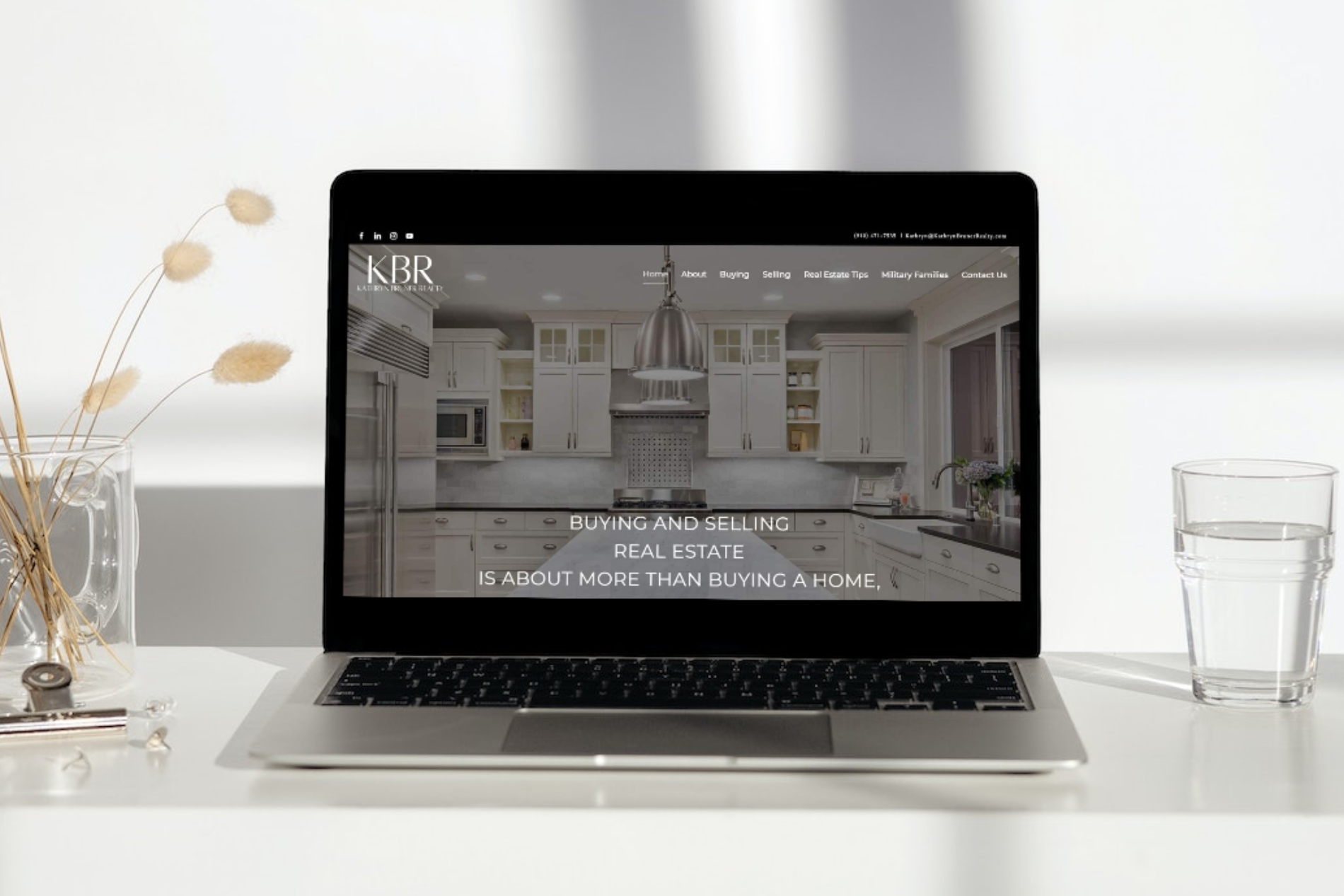 Laptop displaying Kathryn Bruner Realty website homepage